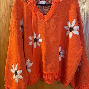 POL Orange V-Neck Sweater with White Floral Design